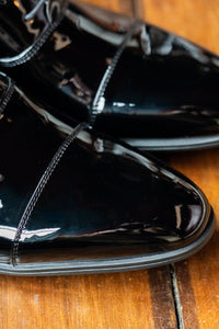 Black toe cap dress shoes by Smart Footwear, showing a close-up of sleek leather shoes with polished black finish