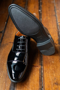 Black toe cap dress shoes by Smart Footwear, featuring polished leather and sleek design for formal occasions.