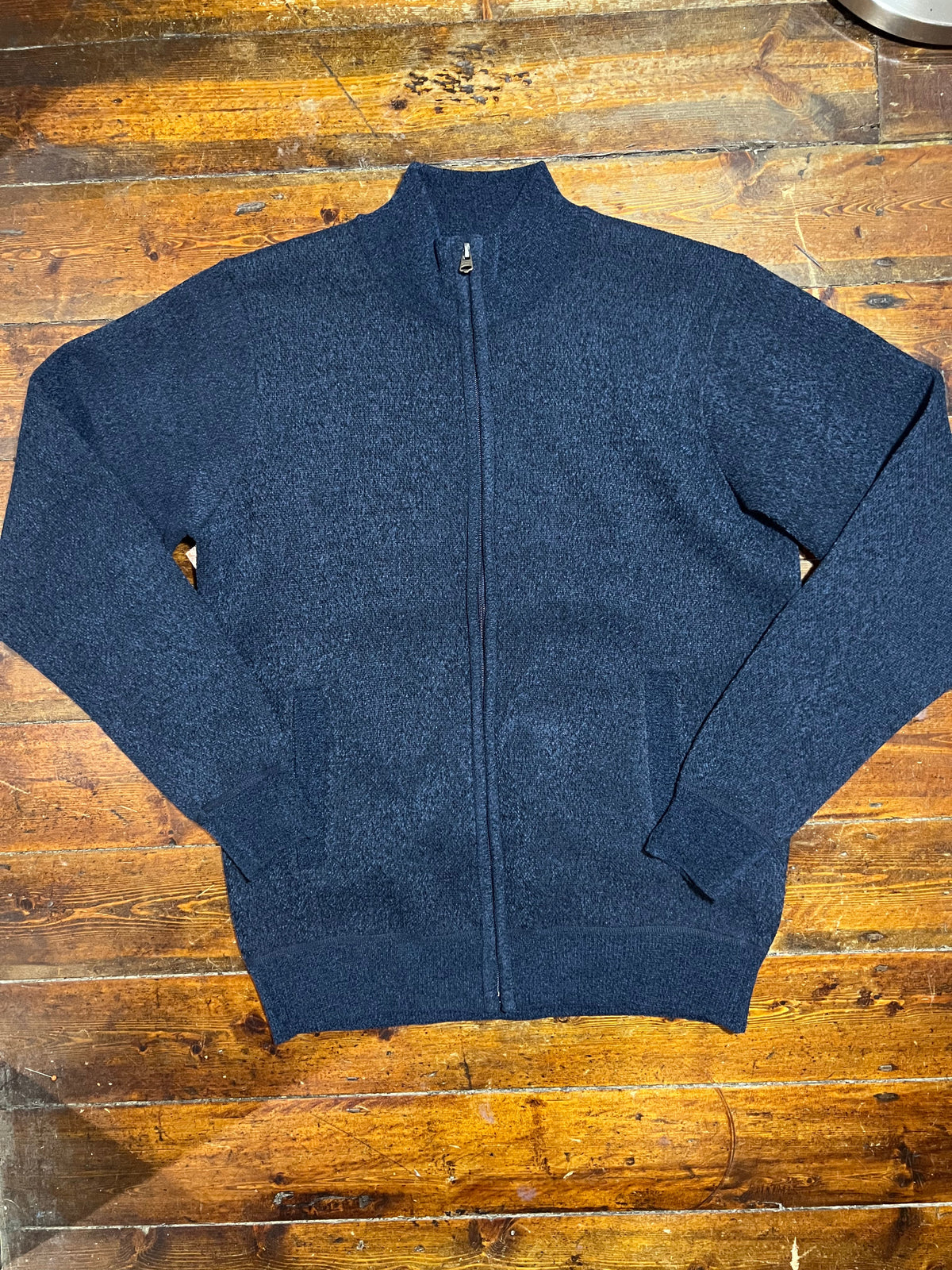 Parfitt navy zip jumper with a high collar and front zipper, made from soft knitted fabric, displayed on a hanger.
