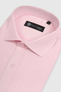 Pink cutaway collar shirt by Paul Andrew Oliver, styled on a mannequin with detailed fabric texture and button-down front.
