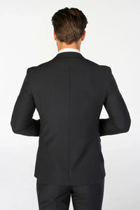 Men's navy blazer by Paul Andrew, styled with a tailored fit and classic lapels, shown on a hanger against a neutral background.