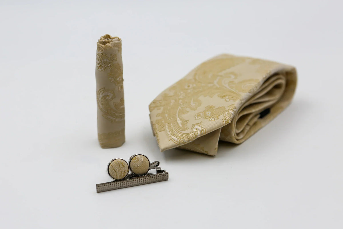 Cream paisley tie by Paul Andrew, featuring intricate paisley pattern, displayed on a neutral background.