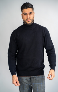 Navy House of Cavani Karris roll neck jumper displayed on a model, featuring a cozy, fitted knit with a high neckline.