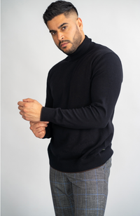 Navy House of Cavani Karris roll neck jumper displayed on a model, featuring a cozy, fitted design with ribbed cuffs and neckline.